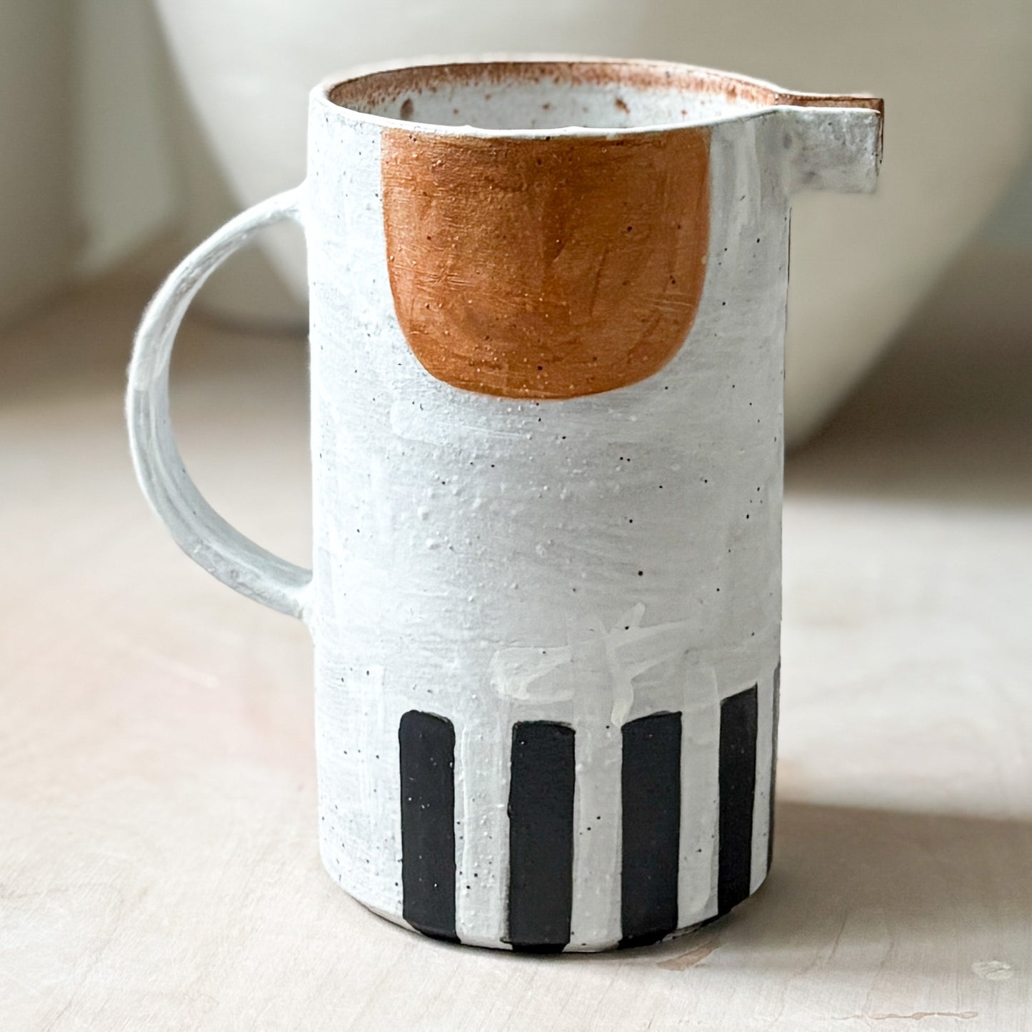Stoneware jug with white slip