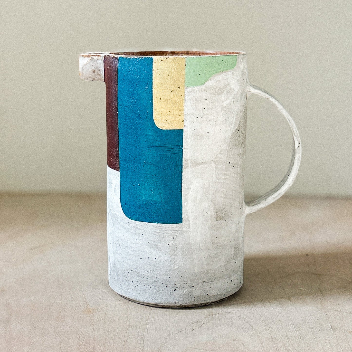 Stoneware jug with white slip