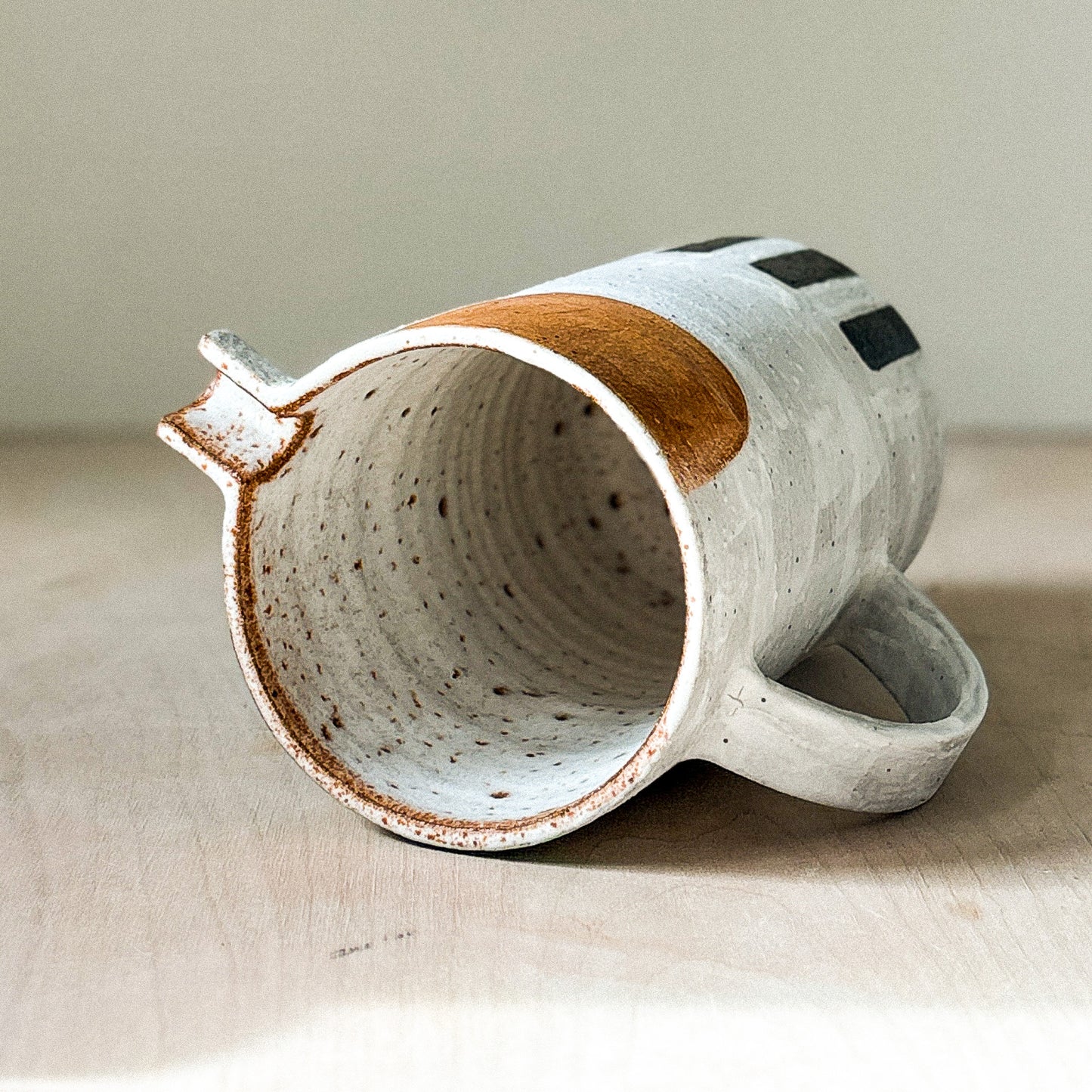Stoneware jug with white slip