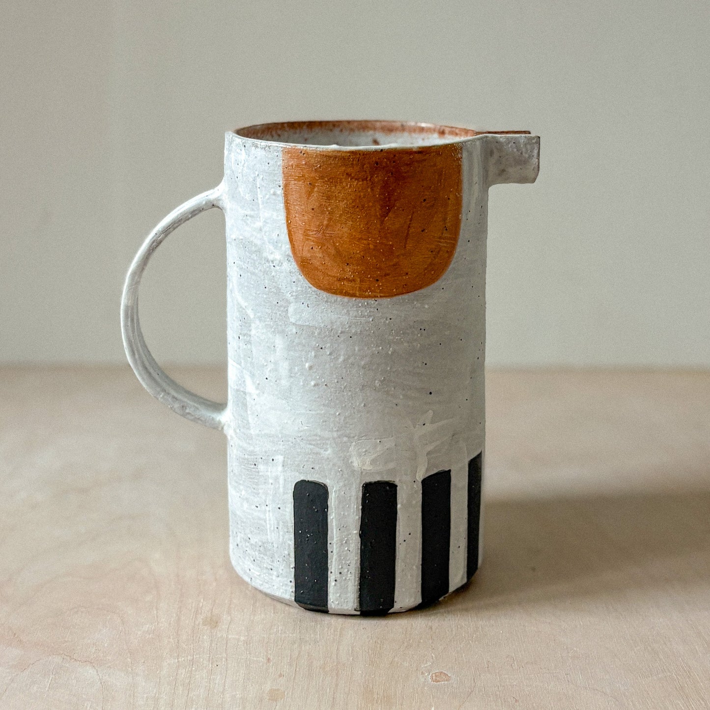 Stoneware jug with white slip